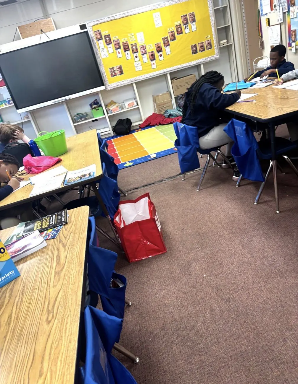 Students writing at their desks during a Books By Me workshop